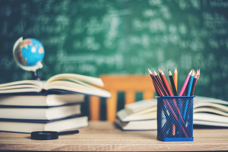 Education books with green board background